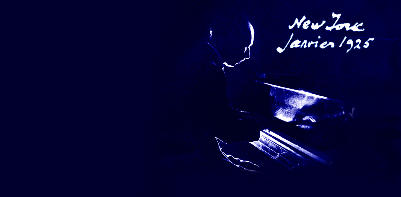 Igor Stravinsky seated at a piano in dramatic silhouette